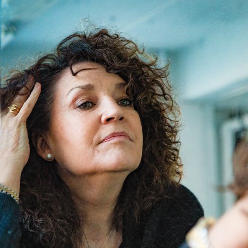 Woman checking the skin on her face