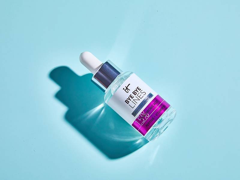 IT Cosmetics Bye Bye Lines Hyaluronic Acid Serum on blue background